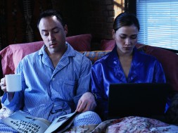 Business Couple Working in Bed