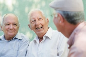 Group of happy elderly men laughing and talking